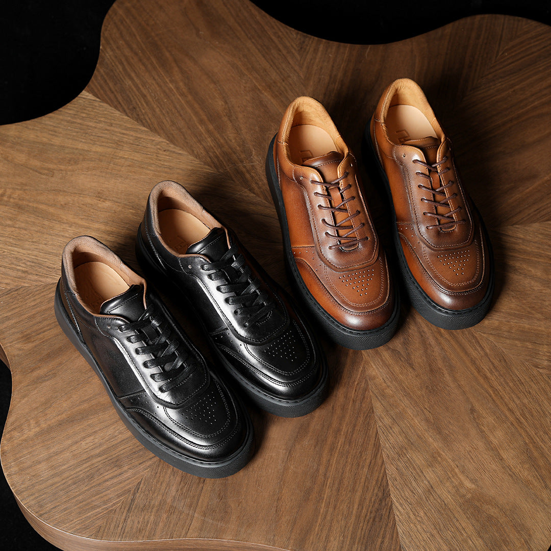 Men's leather sneakers set on wood: black pair and brown pair, lace-up style.