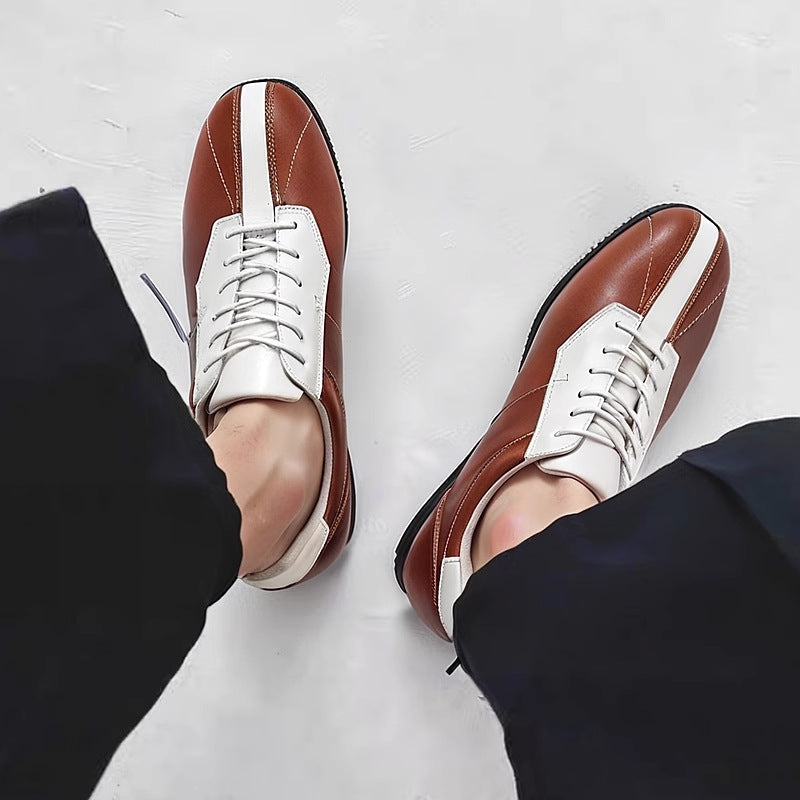 Brown leather low-top sneakers with white lace-up panels and contrast heel tabs.