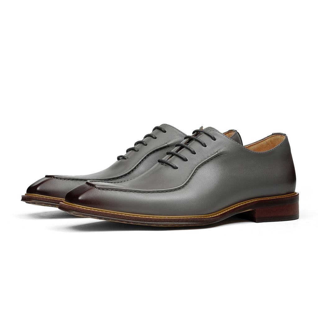 Dark gray chunky lug-sole brogue Oxford shoes with black laces, side profile view