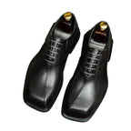 Men's chunky lug-sole wingtip brogue oxfords, black leather look, front pair view.