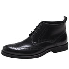 Black wingtip lace-up dress boots with perforated toe and ankle collar