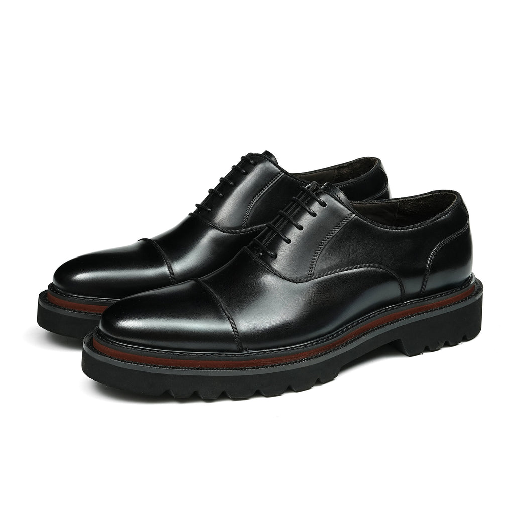 Black lace-up oxford shoes with chunky lug sole and contrast welt