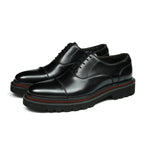 Black lace-up oxford shoes with chunky lug sole and contrast welt