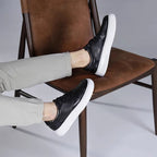 Men's leather sneakers, black, lace-up shoes with low white platform sole.