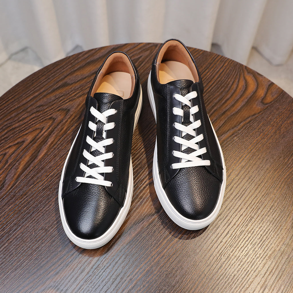 Men's genuine leather sneakers, black top view with white laces and soles