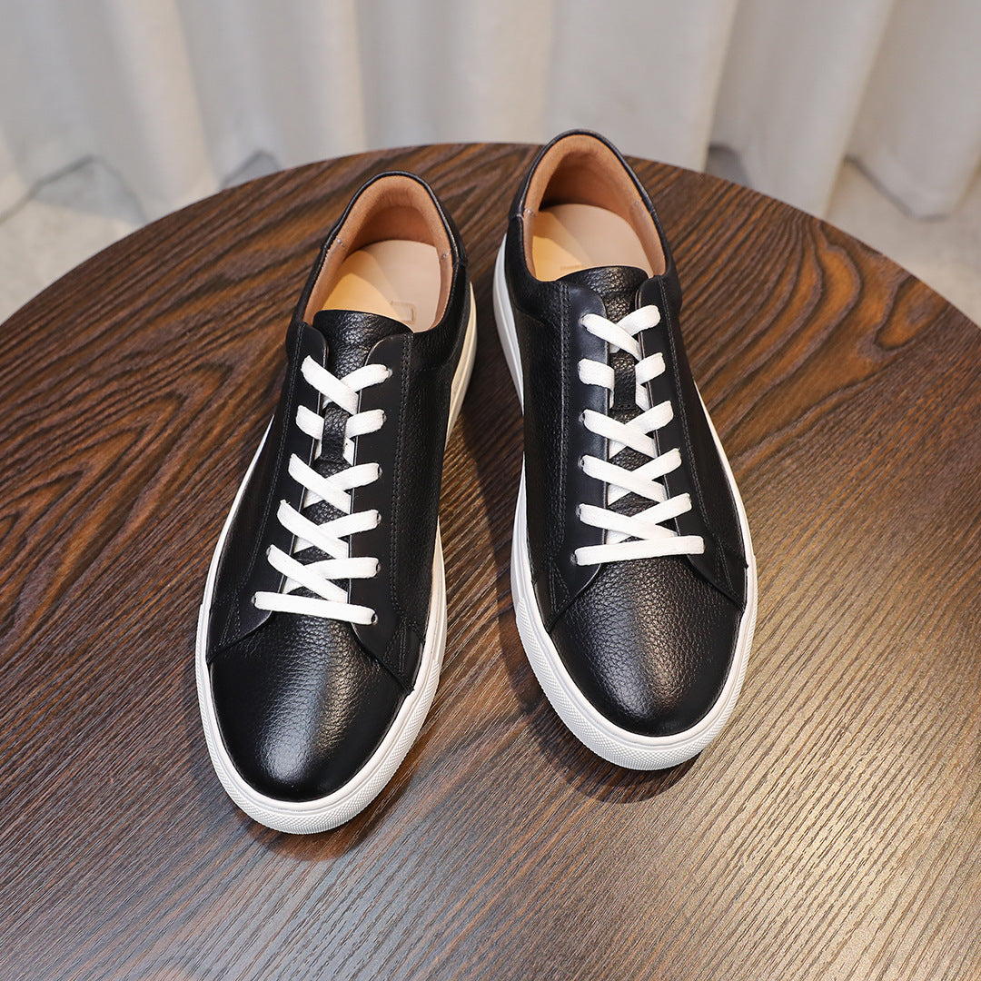 Men's genuine leather sneakers, black top view with white laces and soles