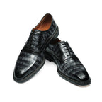 Men's black wingtip brogue oxford shoes with chunky lug sole, angled lace-up pair