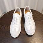 Men's white leather sneakers, lace-up style with padded collar and white rubber sole