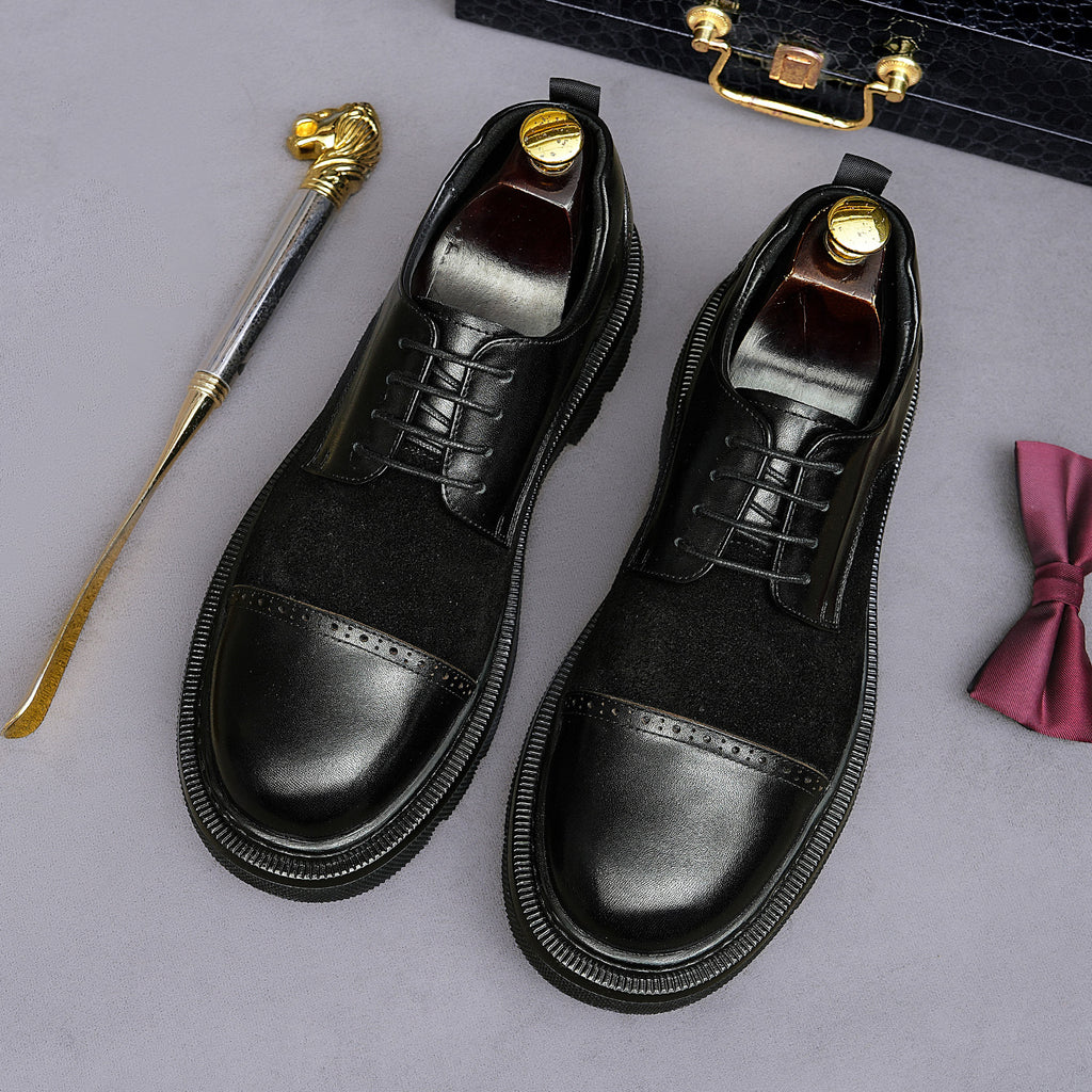 Black lace-up brogue oxfords with wingtip detailing and thick lug outsole