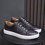 Leather sneakers in black with black laces, embossed side detail, and white sole