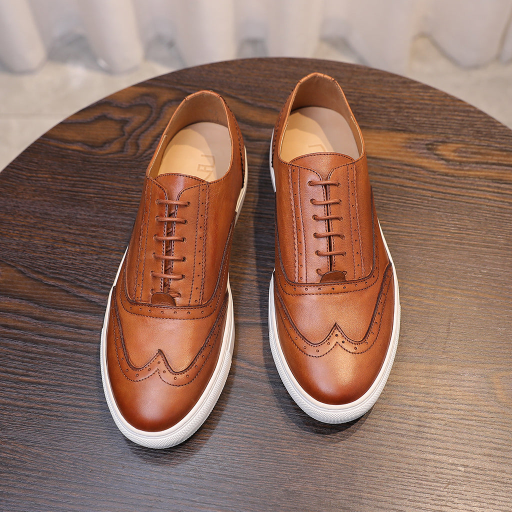 Pair of men's brown leather sneakers with lace-up front and white sidewall sole