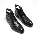 Black lace-up dress boots with wingtip stitching and glossy textured finish