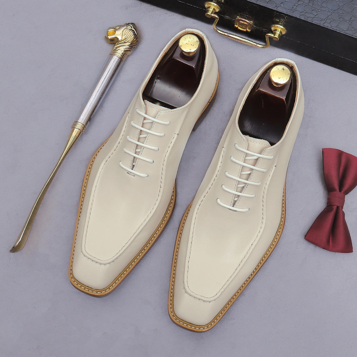 Beige chunky lug-sole brogue Oxford shoes with white laces, lace-up side view