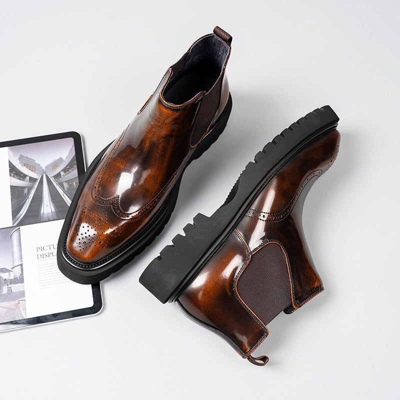 Dark brown leather Chelsea dress boots shown from angled side with chunky tread sole