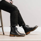 Black leather lace-up side-zip dress boots worn with dark jeans
