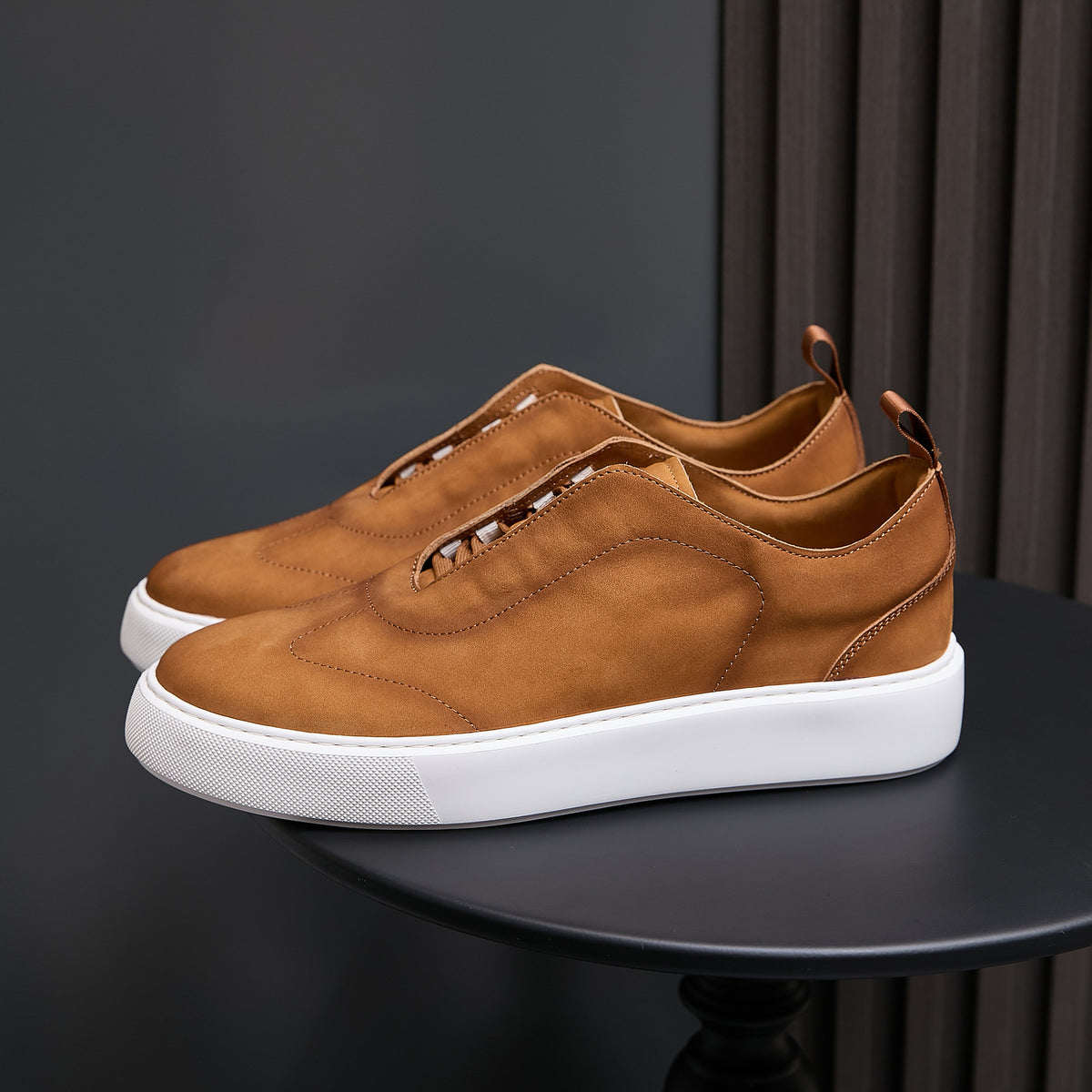 Tan leather sneakers with lace-up design and white rubber sole