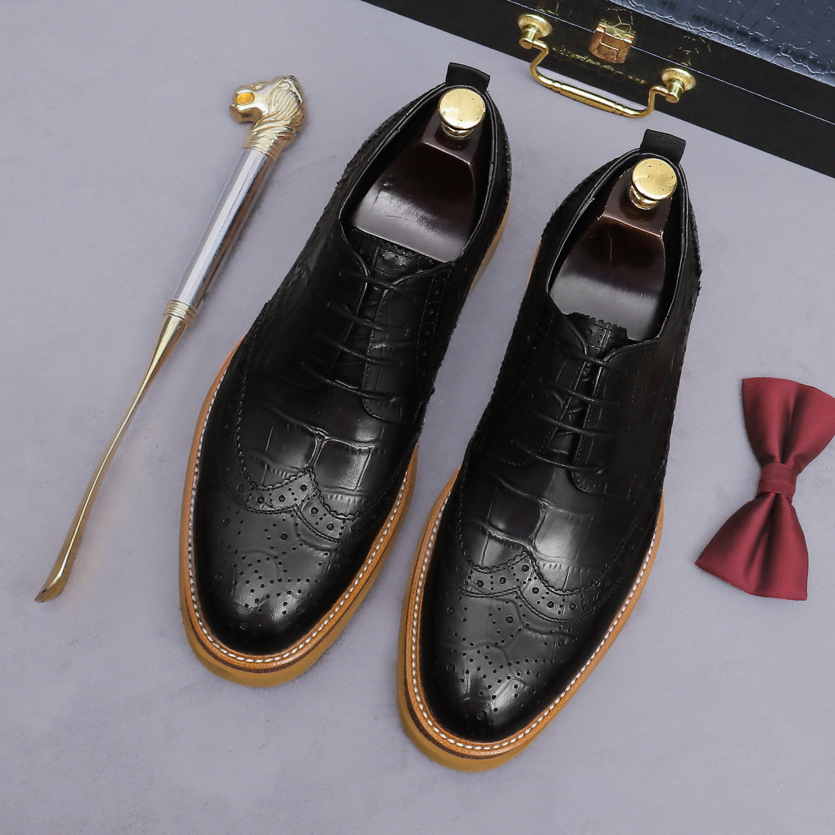 Men's black pointed-toe leather derby shoes, lace-up with wingtip perforations