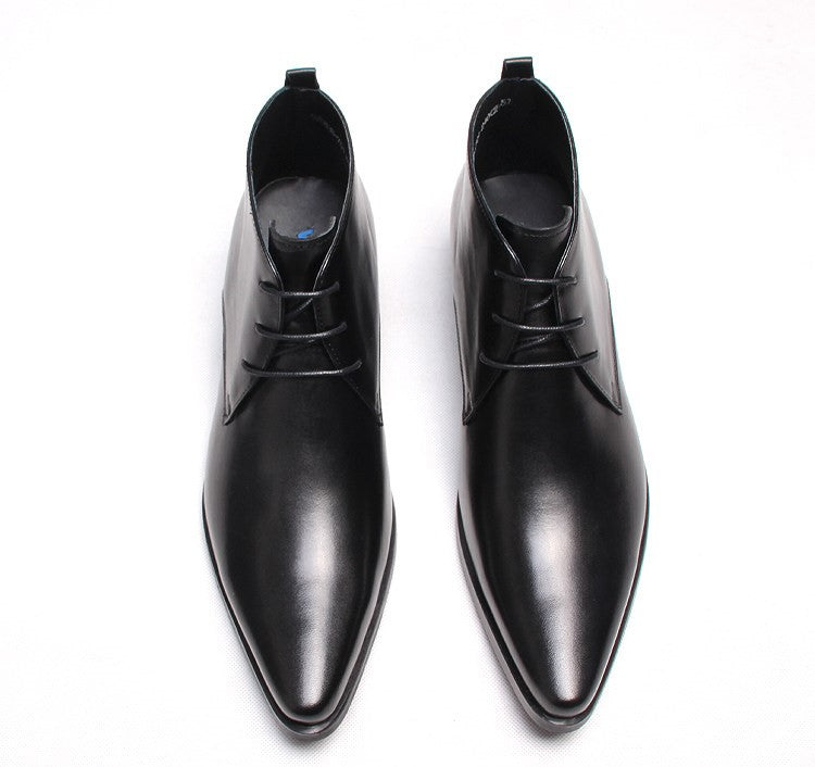 Black leather lace-up dress boots, pointed toe, and lace-up front, flat low heel.