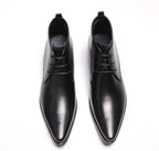 Black leather lace-up dress boots, pointed toe, and lace-up front, flat low heel.