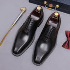 Black wingtip brogue oxford shoes with chunky lug sole and lace-up design