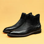 Black leather chelsea dress boots with elastic side panels and lace-up style brogue toe