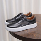 Men's leather sneakers, black, lace-up with white rubber sole and padded collar.