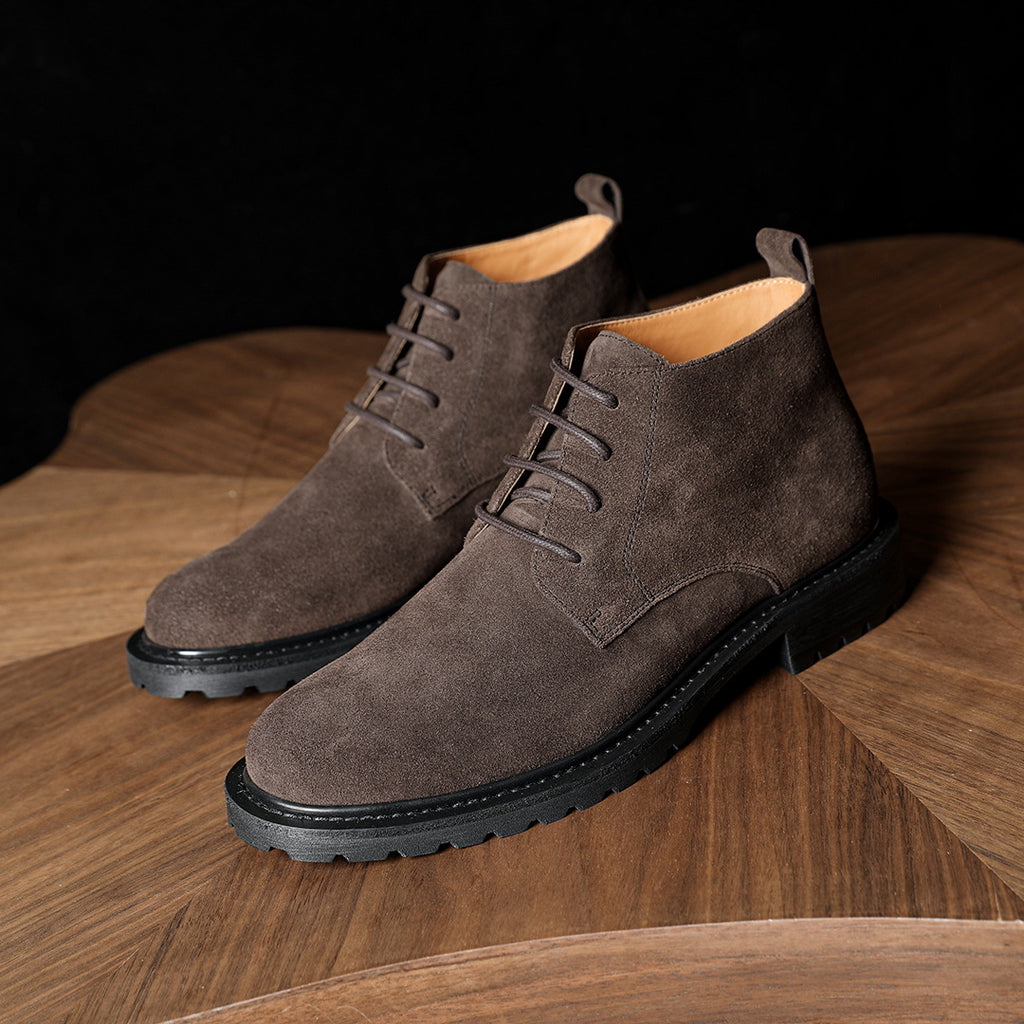 Men's suede chukka boots, plain toe, lace-up closure, dark gray, chunky tread sole.