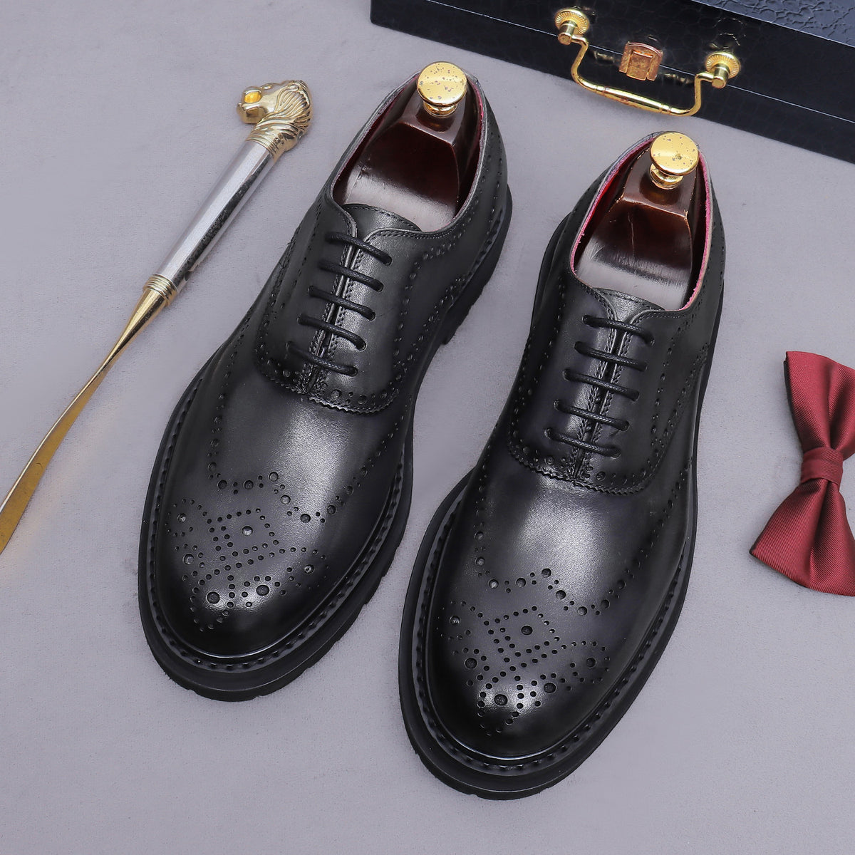 Men's chunky lug sole wingtip brogue oxfords, black pair, lace-up with brogue perforations