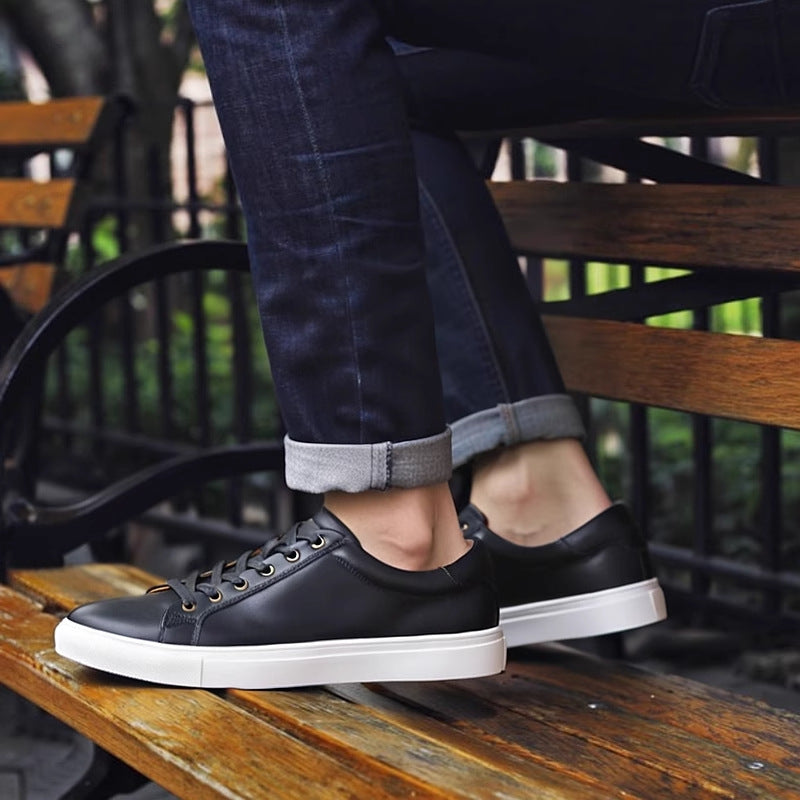 Men's black leather low-top sneakers with lace-up closure and thick white sole
