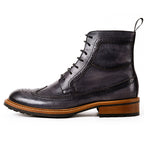 Men's dark leather lace-up chukka boot with ankle panel stitching and tread sole