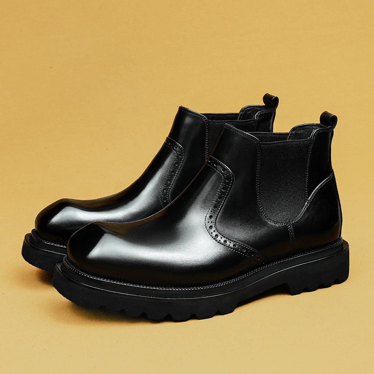 Men's black leather chelsea dress boots with elastic side panels and chunky lug sole