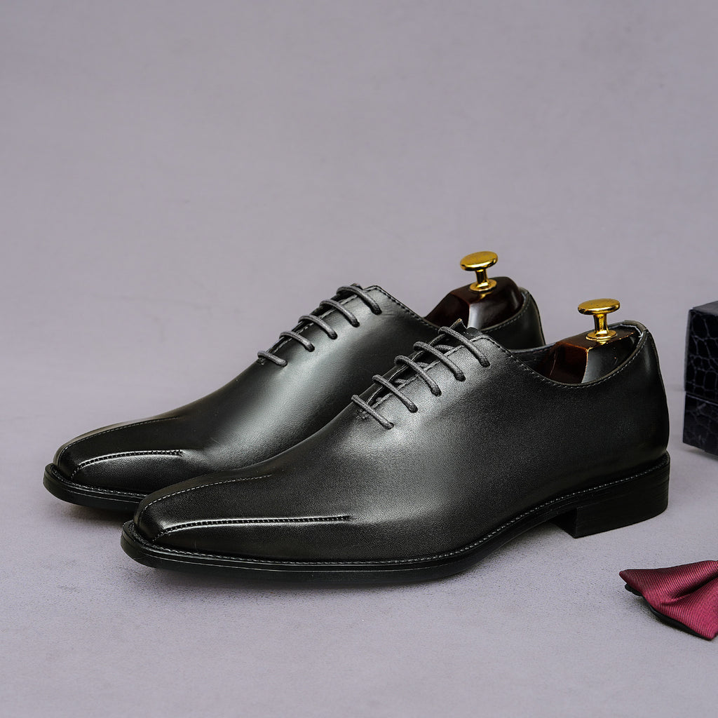 Men's black wingtip brogue oxfords with chunky lug sole and lace-up closure
