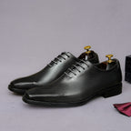 Men's black wingtip brogue oxfords with chunky lug sole and lace-up closure