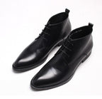 Black leather lace-up dress boots, front view with low heel and stitched upper