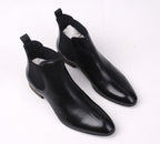 Black leather Chelsea ankle boots with elastic side panels and low heel.