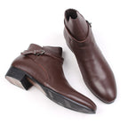 Brown leather pointed-toe ankle boots with side buckle strap and low block heel.
