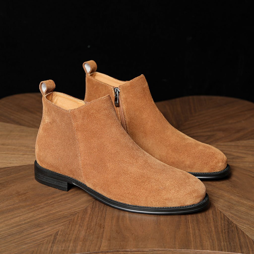 Tan suede ankle boots with pointed toe and side zipper, showing black outsole edge.