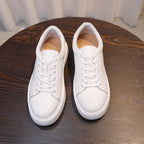 Men's leather sneakers, white, top view showing lace area and padded collar