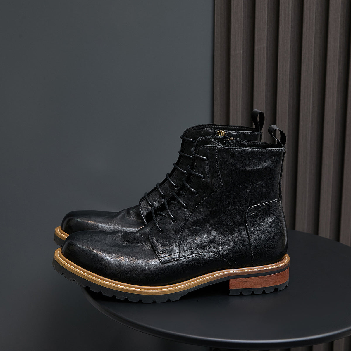 Men's black leather ankle boots with pointed toe, lace-up front, and side zip.