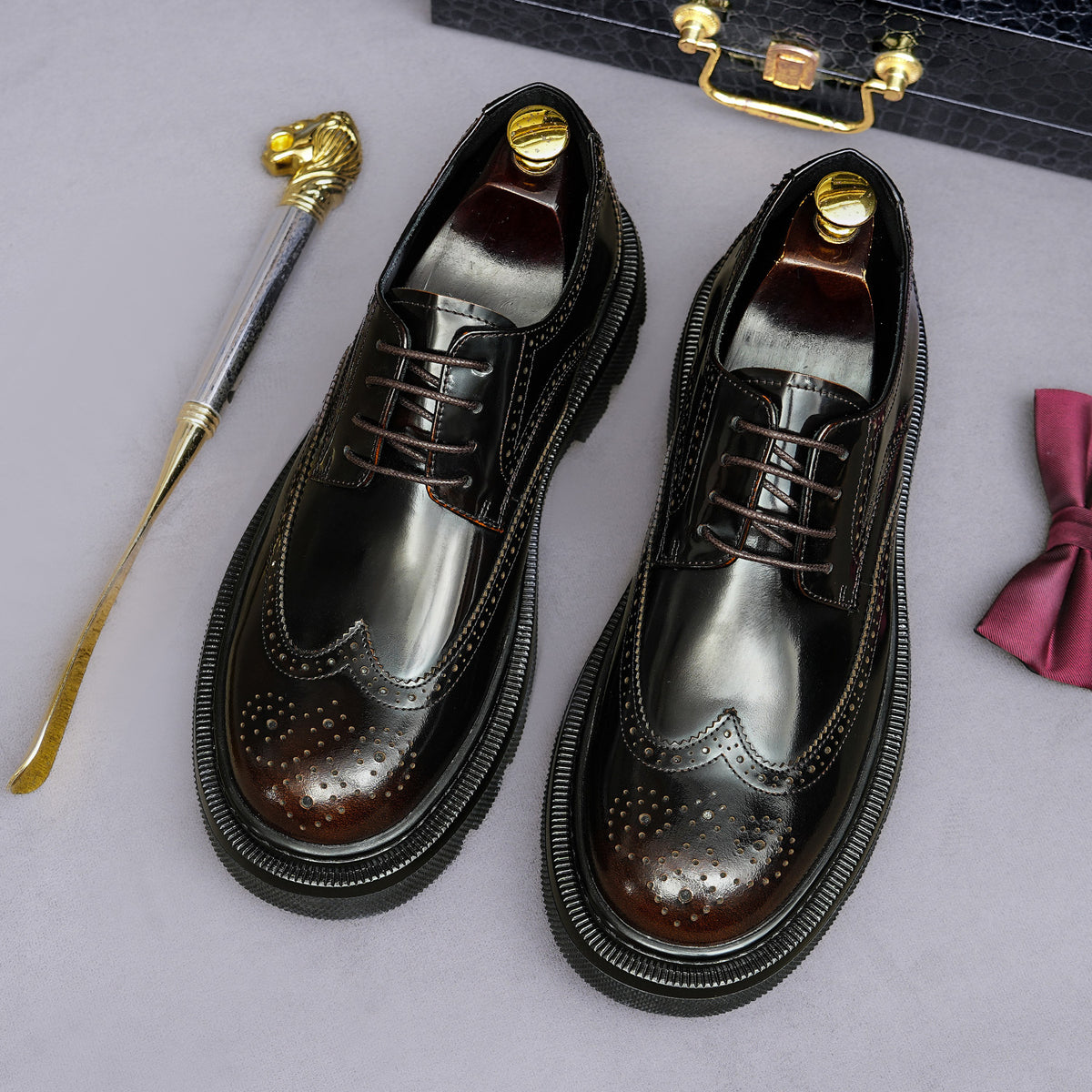 Men's leather pointed-toe derby shoes, lace-up with brogue detailing and dark patina finish.
