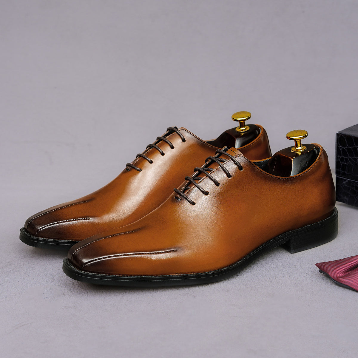 Men's brown wingtip brogue oxfords with chunky lug sole and lace-up closure