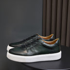 Men's dark green leather sneakers with lace-up front and thick white sole