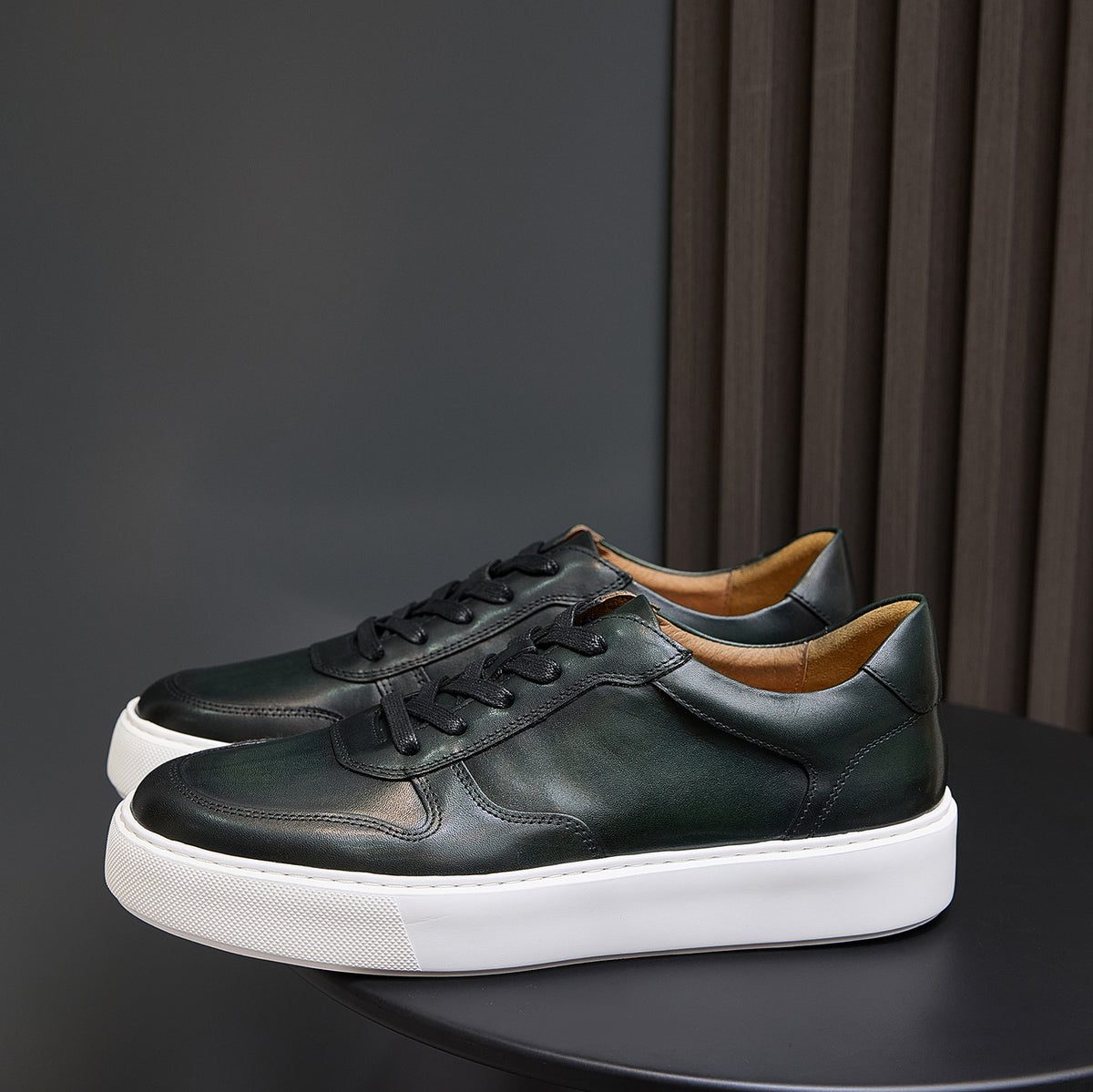 Men's dark green leather sneakers with lace-up front and thick white sole