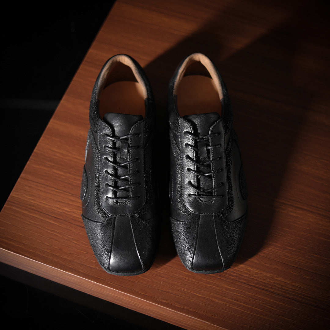 Men's black leather sneakers with lace-up front and oval side panel