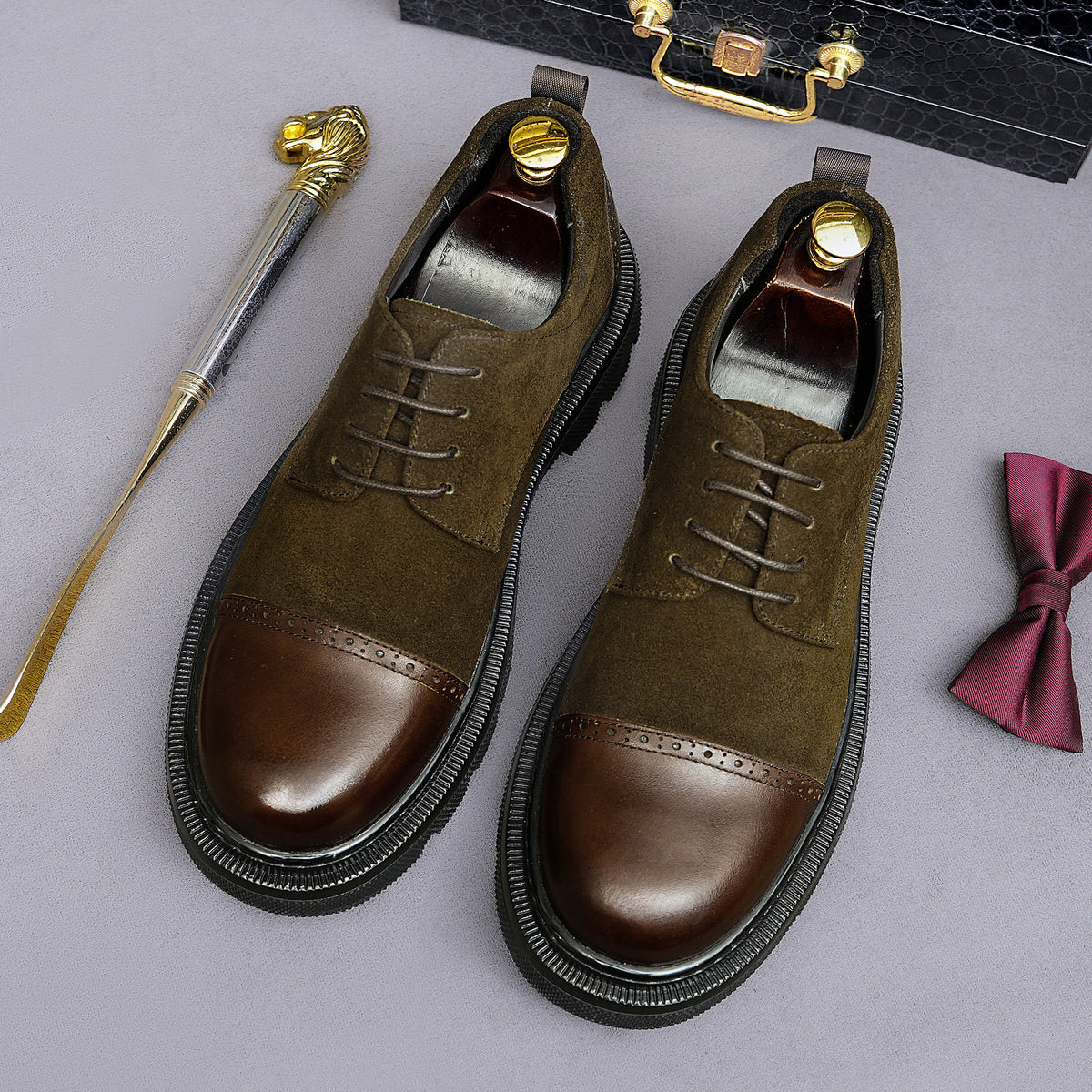 Dark brown lace-up brogue oxfords with wingtip detailing and chunky lug sole