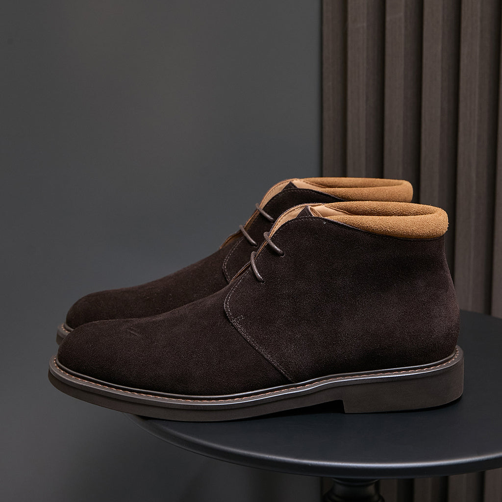 Single men's dark brown suede lace-up chukka boot with tan collar lining