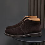 Single men's dark brown suede lace-up chukka boot with tan collar lining