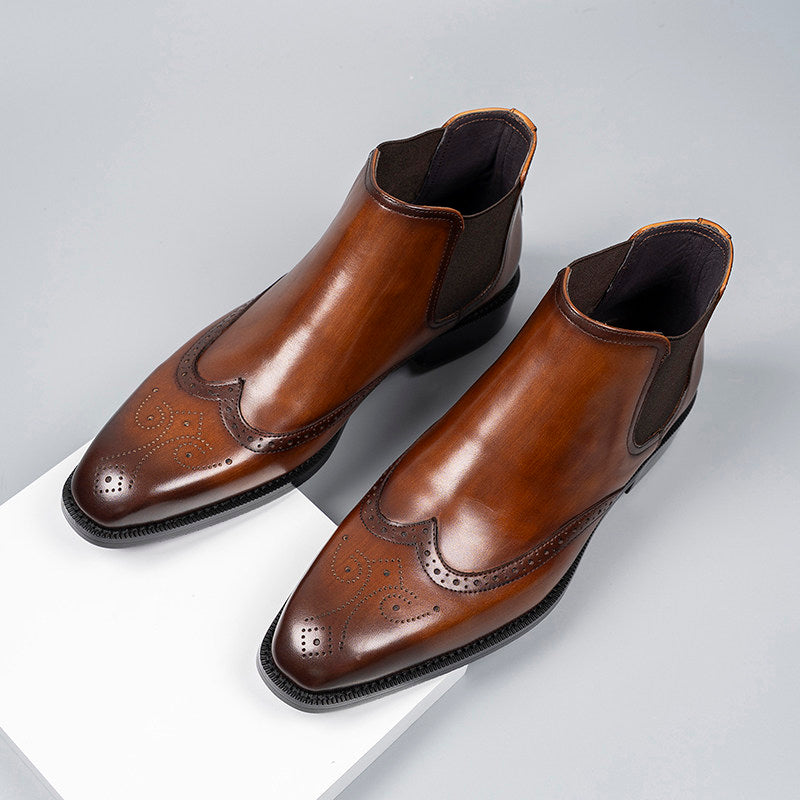 Brown leather Chelsea dress boots with elastic gore, almond toe, and perforated brogue pattern