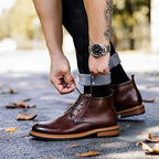 Dark brown leather lace-up chukka boot close-up, plain toe and lace-up vamp.