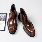 Pair of dark brown leather Chelsea dress boots with brogue perforations and elastic goring